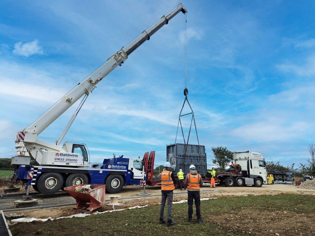 Addfield Cremations human cremator being lifted into position by a crane during installation at a crematorium site